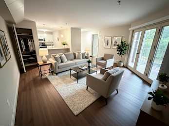 A living room with a white couch and a coffee table.
