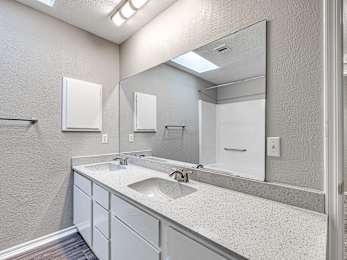 a bathroom with a sink and a mirror at Diamond Ridge Townhomes, Oklahoma