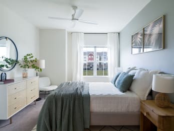a bedroom with a bed and a large window