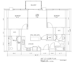A floor plan of a unit with a living room, two bedrooms, a kitchen, a bathroom, and a laundry area.