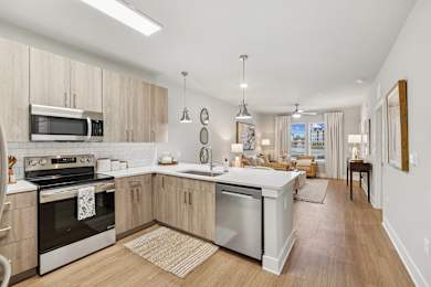 A modern kitchen with wooden cabinets and stainless steel appliances.