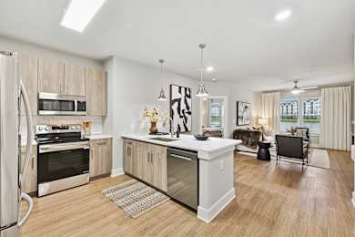 A modern kitchen with wooden cabinets and stainless steel appliances.