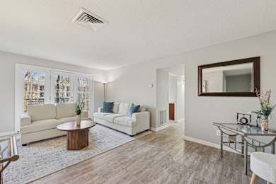 A living room with a white couch and a coffee table.