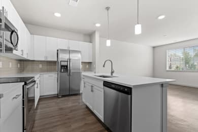 Floor Plan  a renovated kitchen with white cabinets and stainless steel appliances