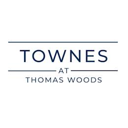A logo with the words "Towne at Thomas Woods" in blue.