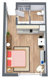 A top-down view of a small apartment with a bed, desk, and kitchenette at The Teale Golden Gate in Naples, FL, 34116