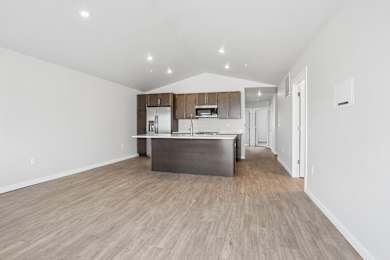 A kitchen with wooden floors and white walls.
