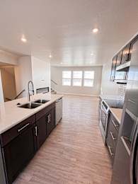 A kitchen with dark wood cabinets and stainless steel appliances.