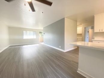 A room with a ceiling fan and light fixture.