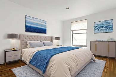 A bedroom with a large bed and a blue blanket.
