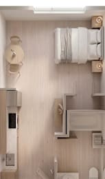 A studio apartment with a bed, table, kitchen sink, and bathroom
