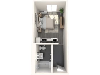 a bedroom with a bed and a desk in a small room