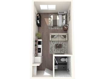 A small room with a bed, a desk, and a kitchenette.
