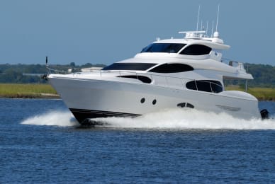 a white and black yacht speeding through the water