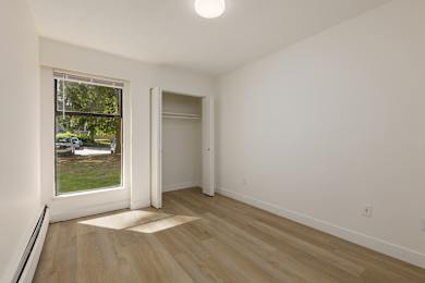 A room with a window and a door.