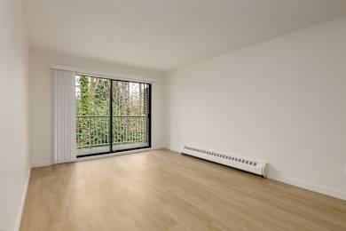 A room with a sliding glass door and a radiator on the floor.