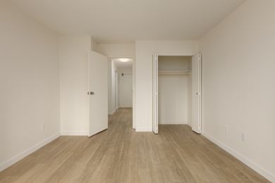 A room with a white door and a white wall.