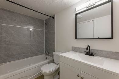 A bathroom with a white toilet and a white sink.