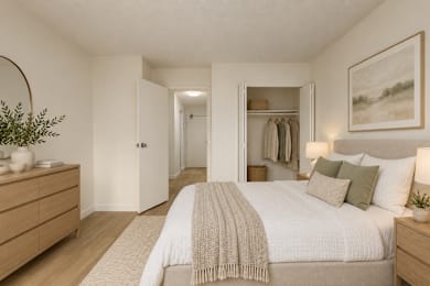 A bedroom with a large bed and a wooden dresser.