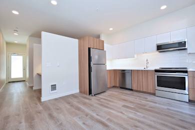 Floor Plan  A modern kitchen with wooden accents and stainless steel appliances.