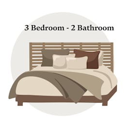A bedroom with three beds and two bathrooms.