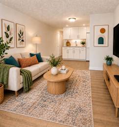Floor Plan  A living room with a white couch, a coffee table, and a rug.