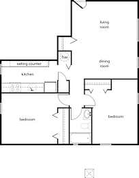 A floor plan of a home with a living room, dining room, kitchen, and two bedrooms.