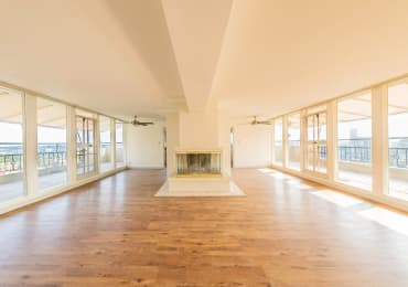 a large empty room with a fireplace in the middle of it