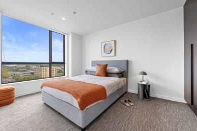 a bedroom with a bed and a window