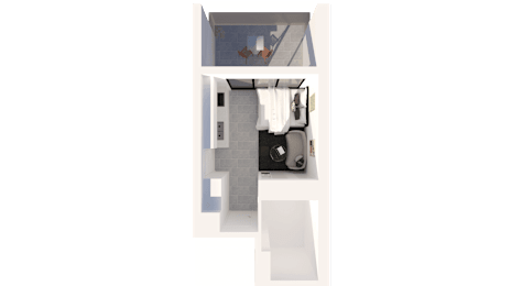 A white chair is placed in front of a small table with a black bag on it.