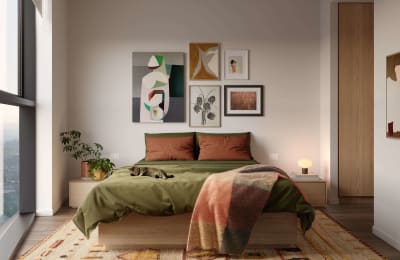 a bedroom with a bed and pictures on the wall