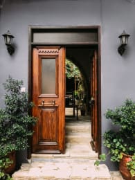 the front door of a building with a wooden door