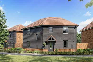 A grey house with a black fence in front.