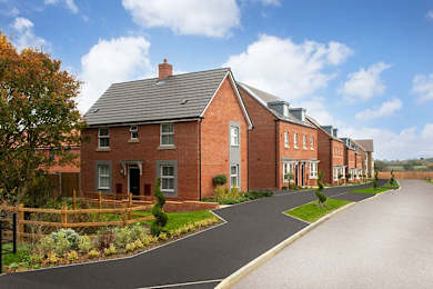 A row of houses with a driveway in front.
