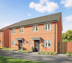 A red brick house with a black roof and a grey door.