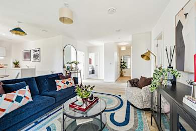 Floor Plan  A living room with a blue couch and a glass coffee table.