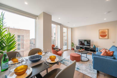 a living room with a large window and a dining room table