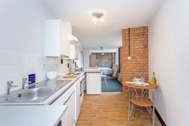 Floor Plan  a kitchen with a sink and a table with a chair