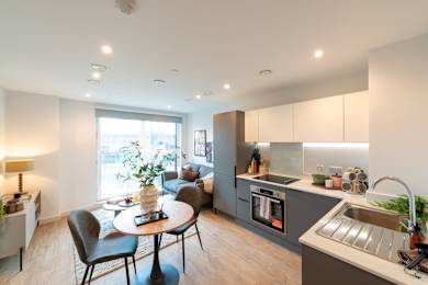A modern kitchen with a dining table and chairs.