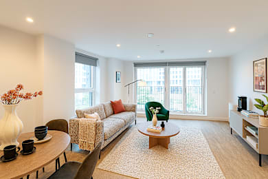 A living room with a sofa, a coffee table, and a chair.