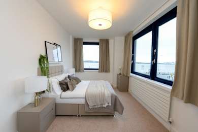 a bedroom with a bed and a large window at The Keel Apartments, Liverpool, L3 4GE