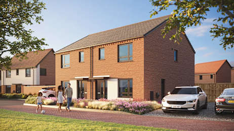 A modern house with a red brick exterior and a couple walking in front.