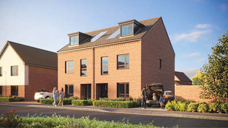 A large brick building with a car parked in front and two people walking towards the building.