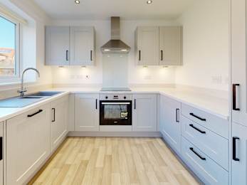 Floor Plan  A modern kitchen with wooden floors and white cabinets.