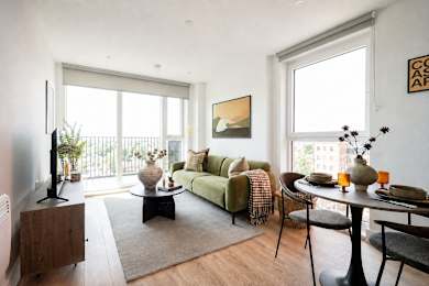 A living room with a green couch and a coffee table.