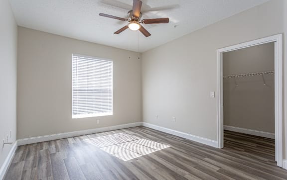 Floor Plan  A room with a ceiling fan and a window with blinds.