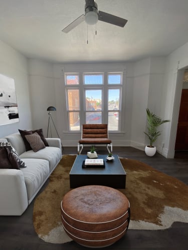 Floor Plan  a living room with a white couch and a coffee table