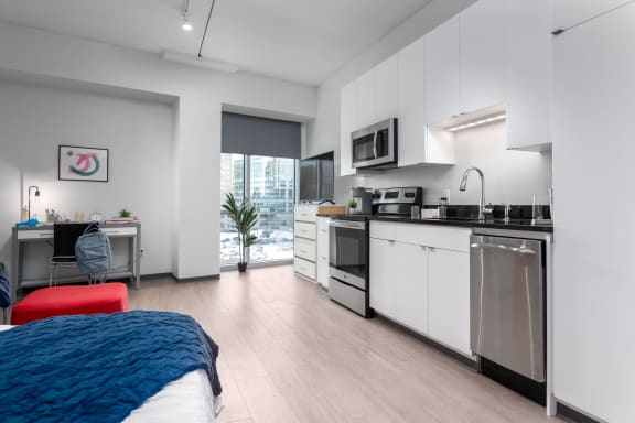Floor Plan  a bedroom with a bed and a kitchen with a sink