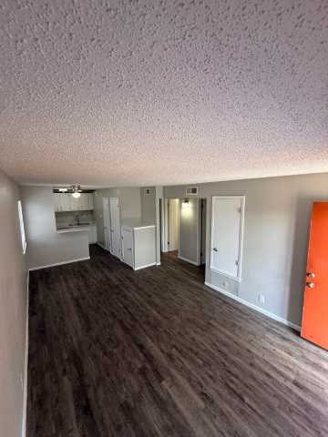 Floor Plan  A room with a white ceiling and a brown floor.