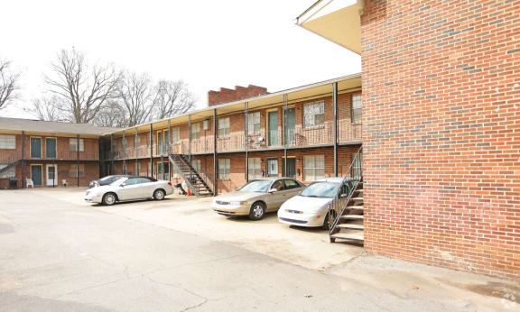 Floor Plan  a parking lot with cars in front of a brick building